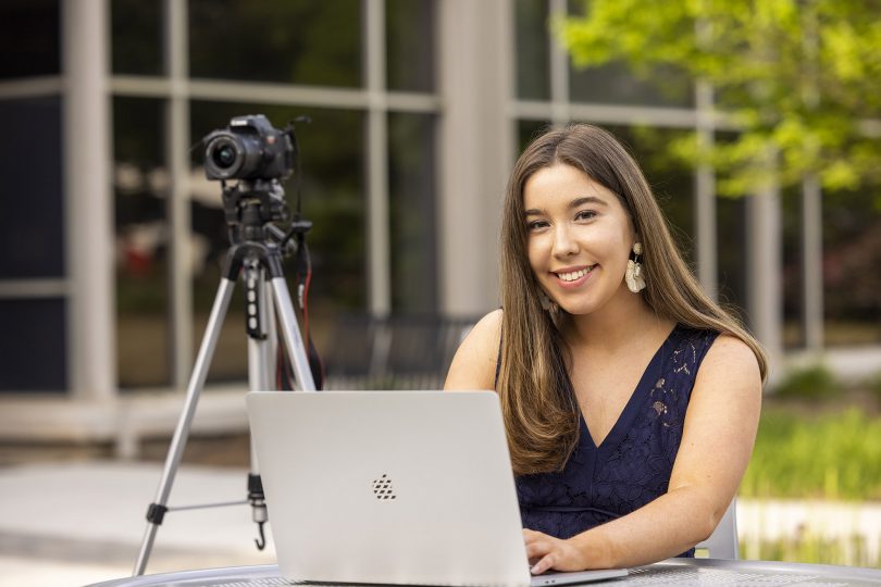 Kelly Krincek with her laptop and camera