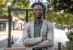 Joshua Williams stands in front of the Arch on North Campus.
