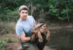 Michael Skibsted in Atlanta holding a spry common snapping turtle (Chelydra serpentina). (Photo by Ken Wang)